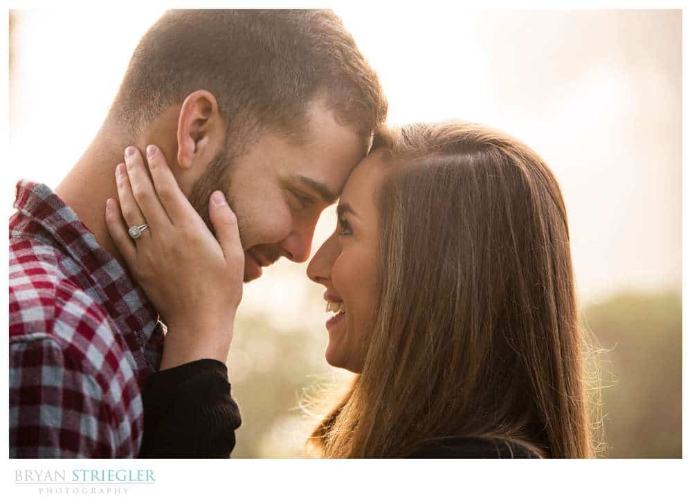 engagement photo with sun behind them